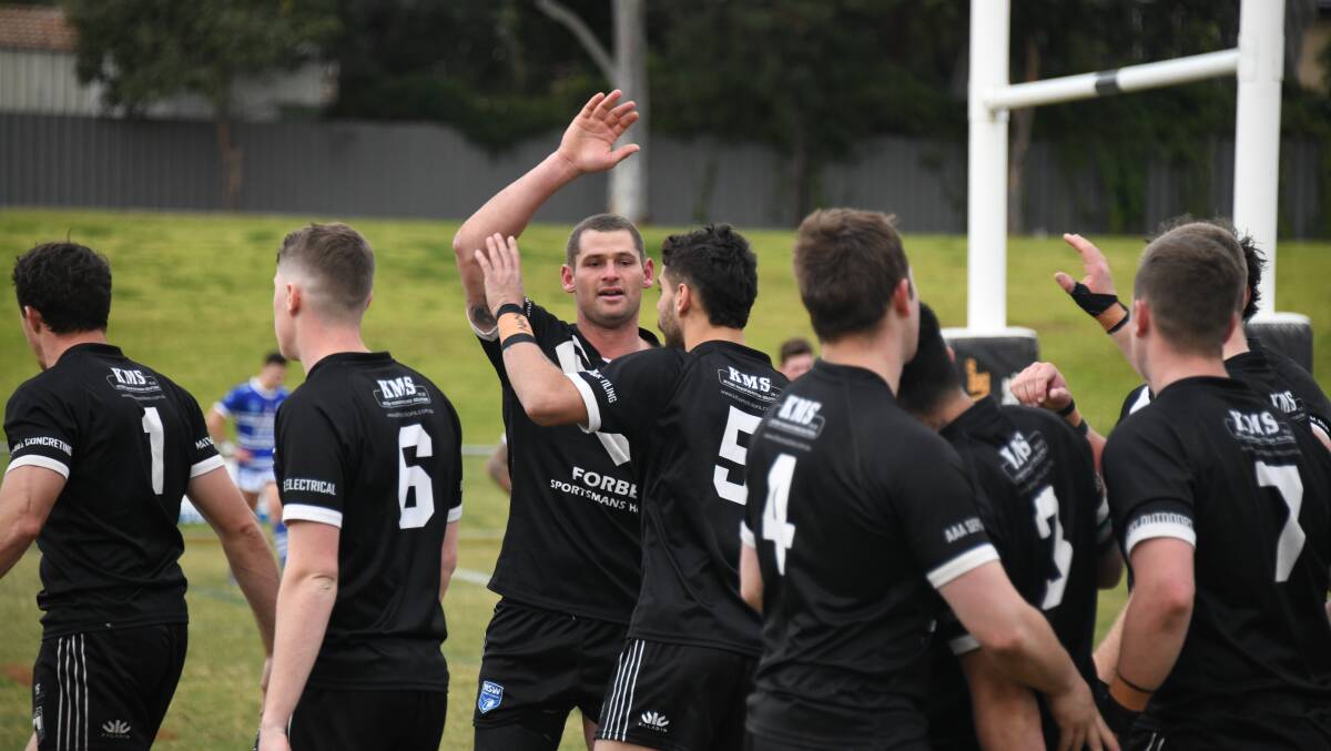 FOUR POINTS PLEASE: Magpies enforcer Jake Grace celebrates a try with his uninjured hand during Saturday's match against Macquarie. Photo: AMY McINTYRE