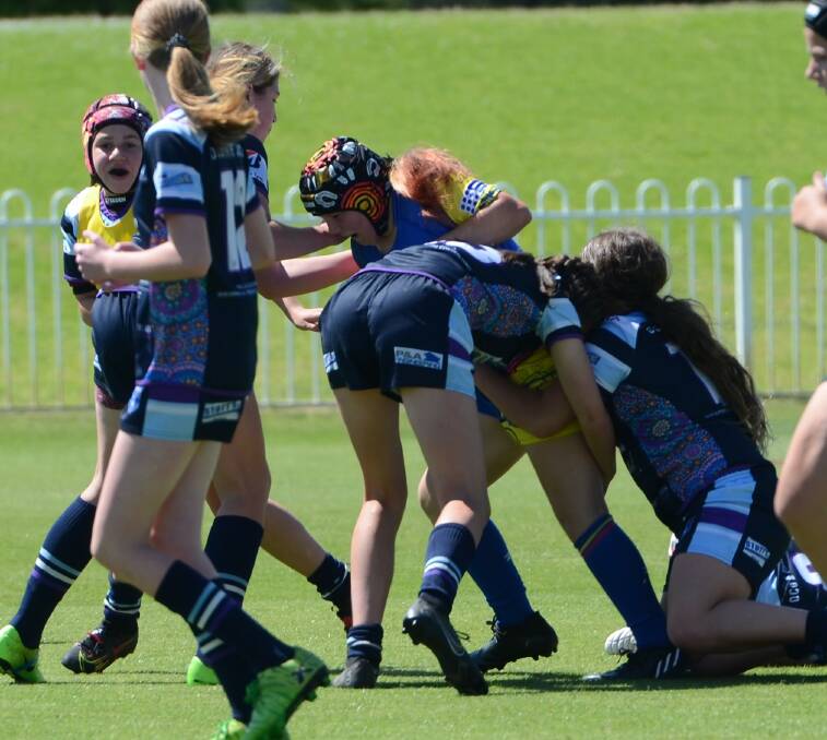 Natarleah McKinnon drags Brumbies defenders with her as she makes good metres for the Platypi. Picture by Anya Whitelaw