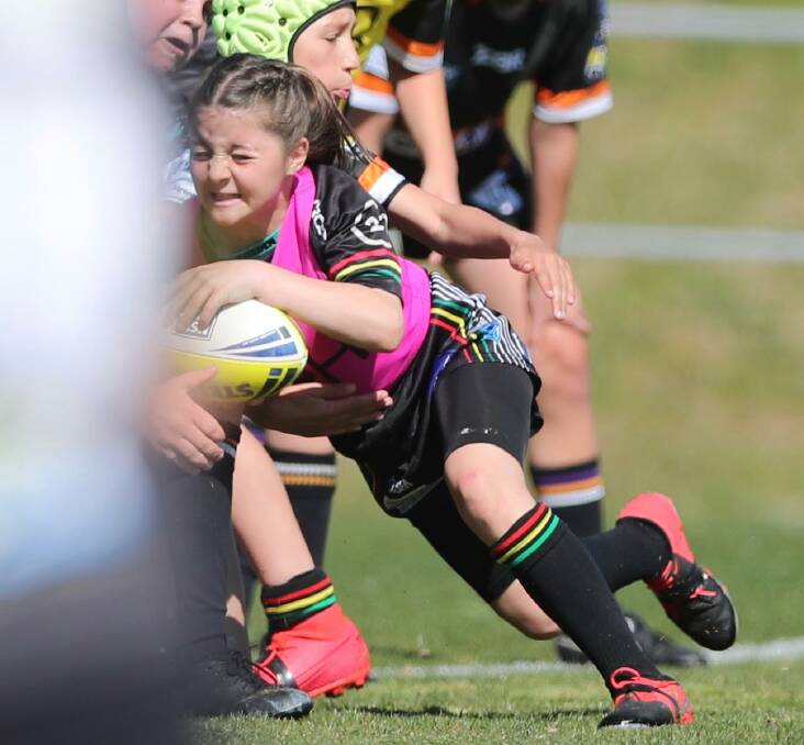 TRY TIME: Freya Hodges catches out Lithgow's marker defence as she dives over the line for a try in the under 11s tackle semi-final. Photo: PHIL BLATCH