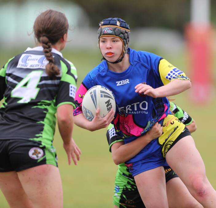 GIVE THEM MORE: Layla Rumball takes a carry for the under 16 Platypi. Players get just five rounds of football plus finals in the current WWRL format. Photo: PHIL BLATCH