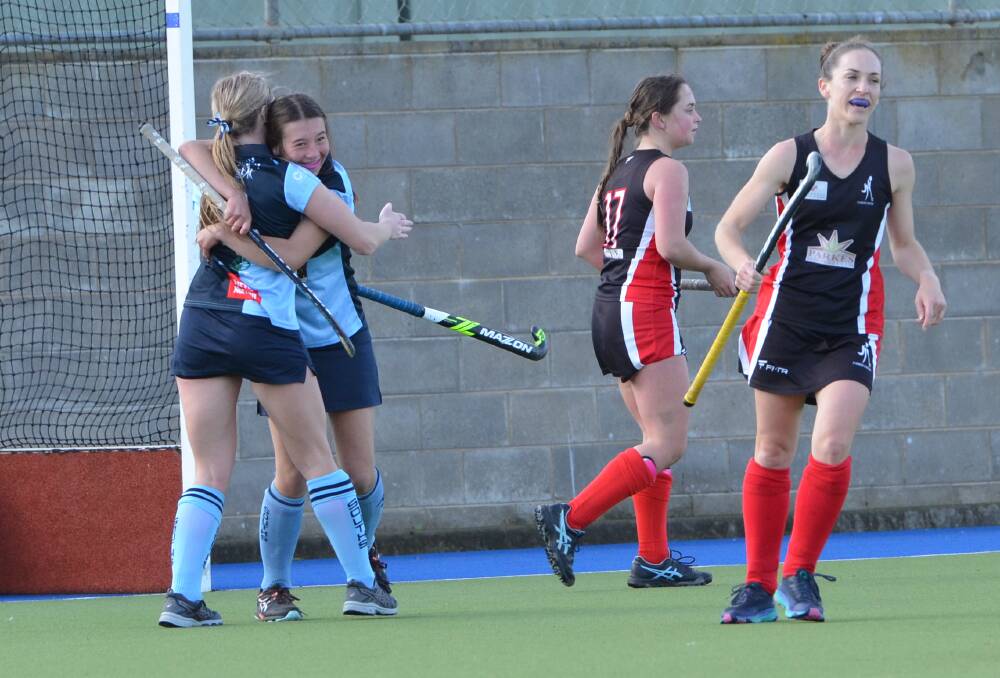 MOMENT OF JOY: Sam Brown and Pip Webb celebrate after Souths' first goal of the Central West Premier League Hockey season. Photo: ANYA WHITELAW