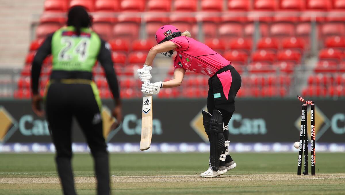 GONE: This Lisa Griffith delivery crashes into the stumps of Sydney Sixes opener Ellyse Perry during Wednesday's WBBL derby. Griffith was player of the match as Thunder won by eight wickets. Photo: AAP