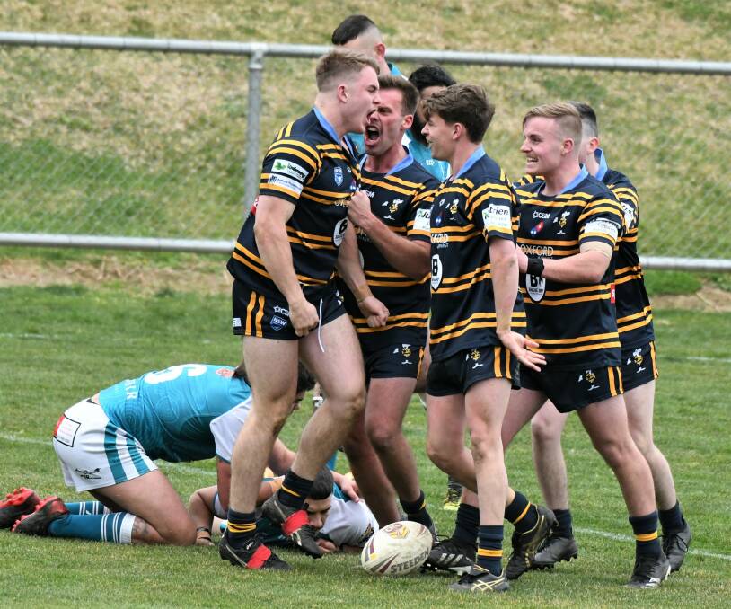 BIG MOMENT: Zac Hunt (left) celebrates after scoring CSU's first try of the grand final. It was part of a performance which saw him named man of the match. Photo: CHRIS SEABROOK