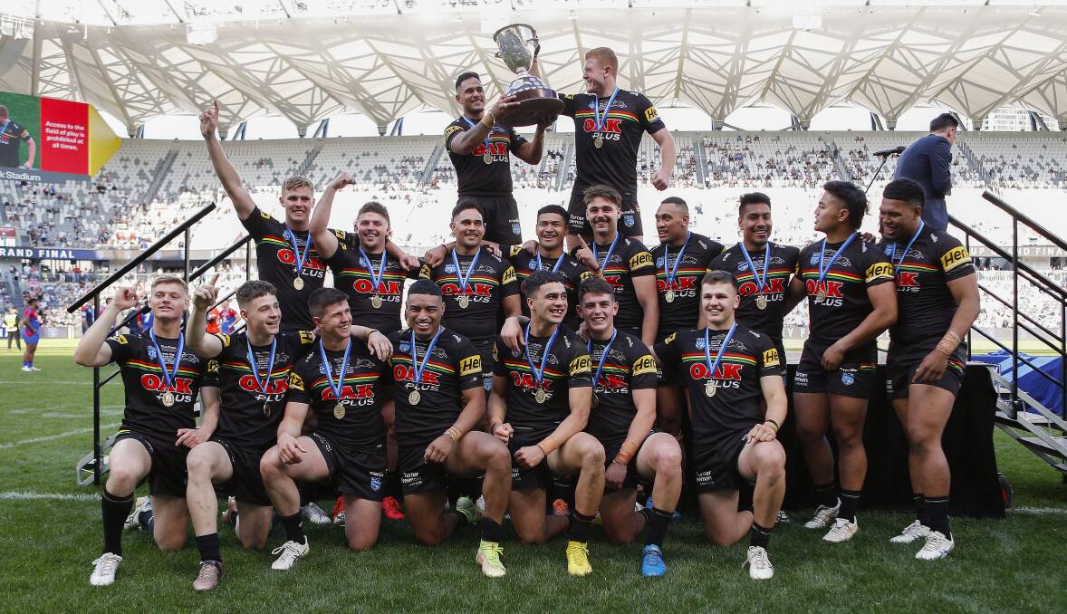 Bathurst talent Brad Fearnley (back right) helps Penrith skipper Hohepa Puru raise the premiership trophy after Sunday's thrilling Jersey Flegg Cup grand final win. Picture by Bryden Sharp