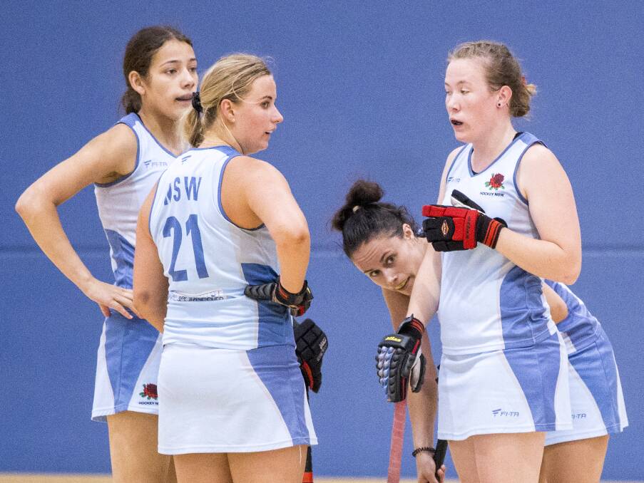 TALKING TACTICS: Bathurst hockey talent Sarah Watterson (right) discusses a plan with her NSW team-mates. Photo: CLICK INFOCUS