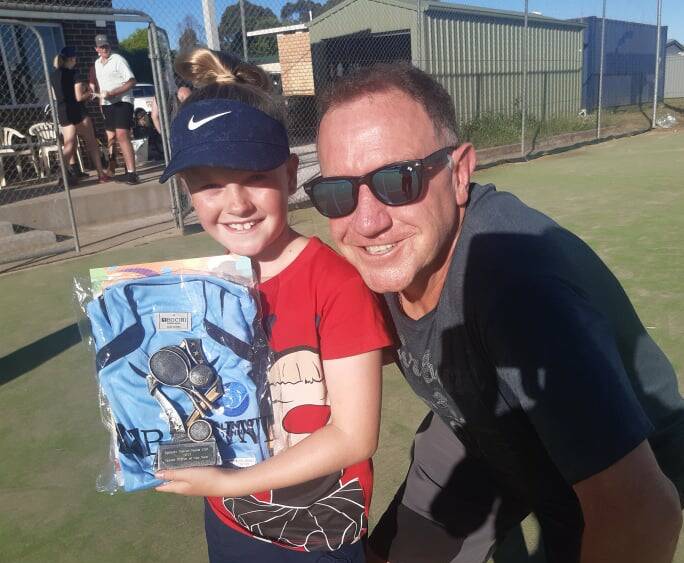HOT SHOT: Garth Hindmarch presents the inaugural Paige Hindmarch Player of the Year award to nine-year-old Hannah Skein. Photo: CONTRIBUTED
