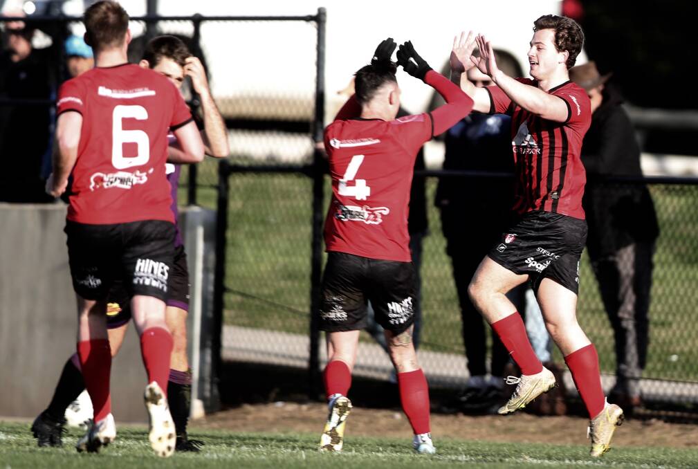 Ryan Campbell celebrates with his team-mates after putting Panorama 2-0 up against Parkes. The Goats went on to win the preliminary final 3-2. Picture by Phil Blatch