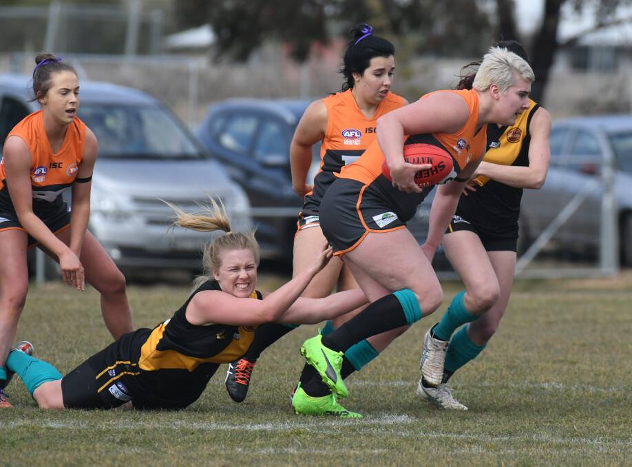 STRENGTH: Bathurst Giants ruck woman Laycee Covington-Gorst bursts through an attempted Orange Tigerettes tackle. Photo: JUDE KEOGH