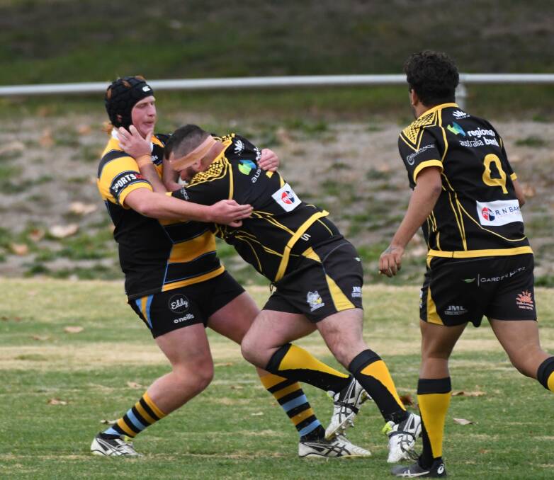DEFENCE: CSU's Lachlan Buckton - who has been selected for NSW Country - brings a Dubbo Rhinos rival to a halt. Photo: CHRIS SEABROOK
