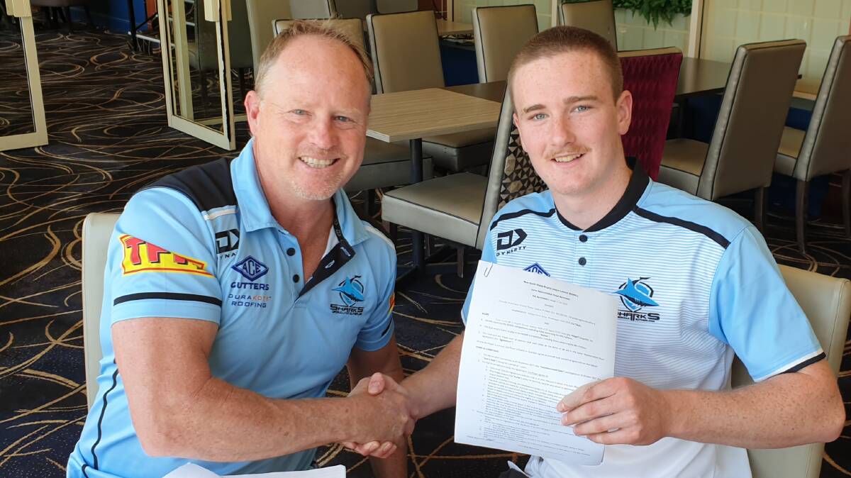 SIGNED UP: Cronulla Sharks talent identification manager Glenn Brailey, with St Pat's junior Tyler Colley as he signs a new contract. 