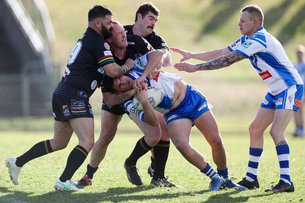 GREAT TUSSLE: Saints lock Aaron Mawhinney is halted by a three-man Panthers tackle. Photo: PHIL BLATCH
