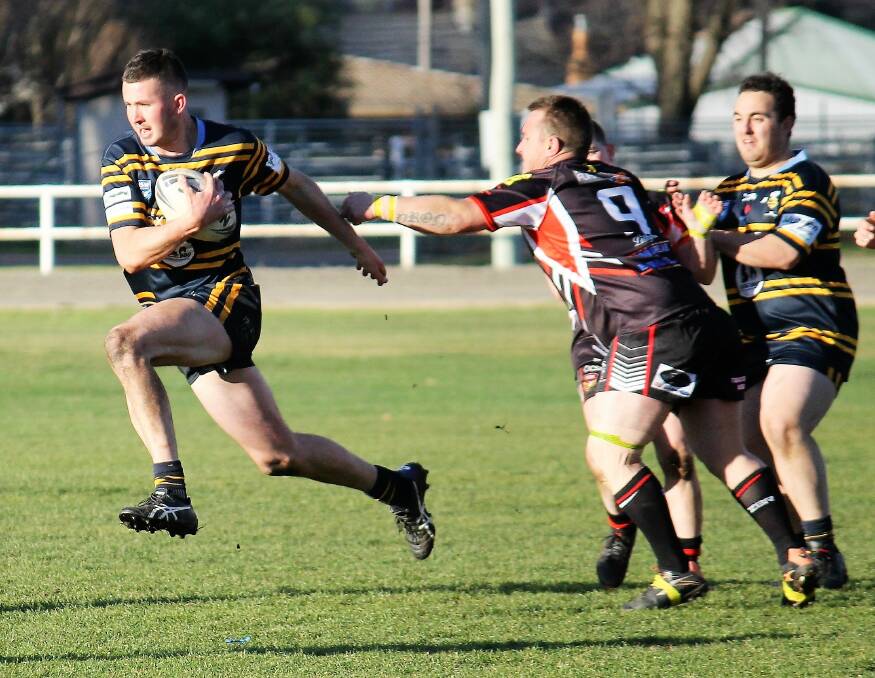 FLYING FIN: CSU second rower Fin Grabham avoids the grasp of a Lithgow rival in their Mid West Cup match. Photo: JOHN FITZGERALD