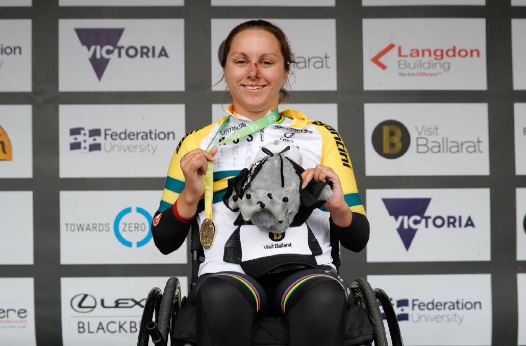 TOUGH COMPETITOR: Still sporting the cuts after her crash in the time trial, Emilie Miller shows off her road race gold medal. Photo: CON CHRONIS/CYCLING AUSTRALIA