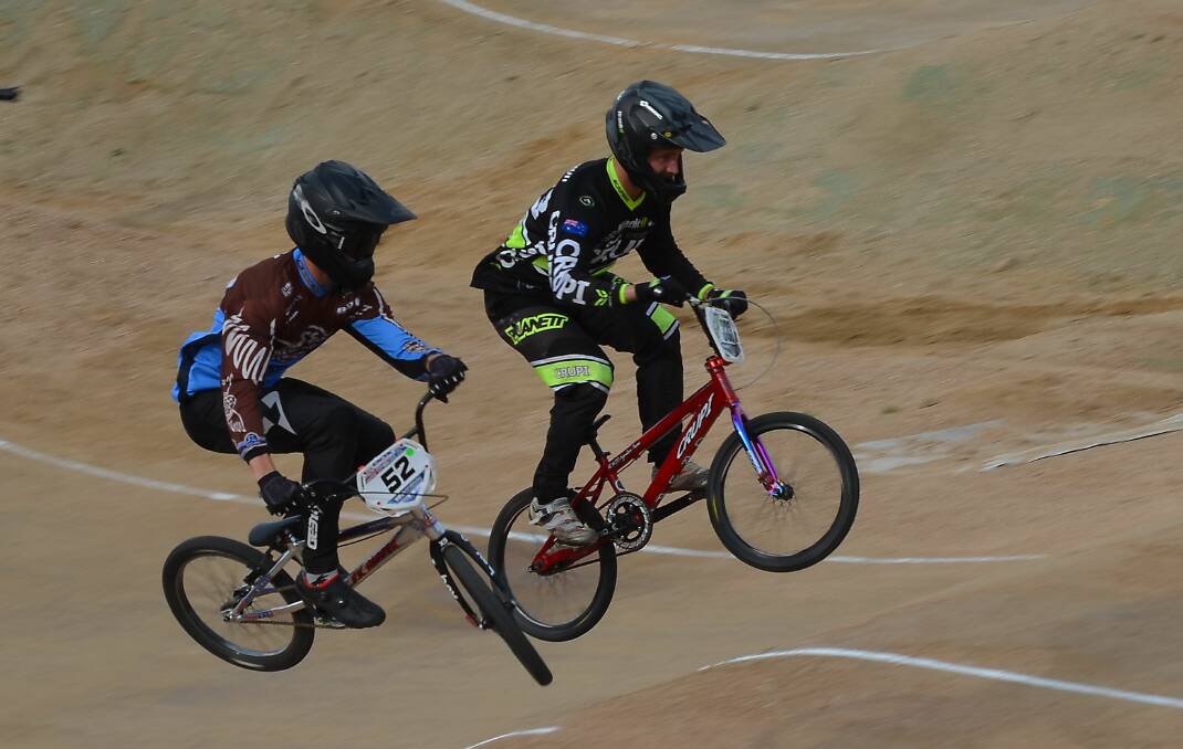RIVALS: Alex Cameron leads the way over Cody Fox in the men's superclass final at the Bathurst BMX track on Sunday. Photo: ANYA WHITELAW