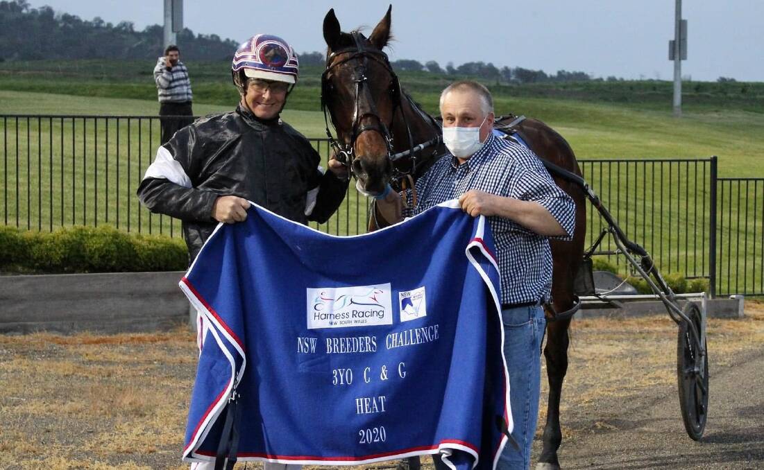 STAR PERFORMER: Regular driver Jason Turnbull and Oberon trainer Wayne White pose with Jerulas Grin after one of his six career wins. The gelding will now be aimed at the Chariots Of Fire. Photo: AMY REES
