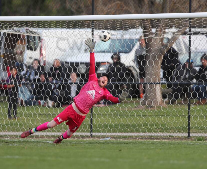 Diving Panorama FC goalkeeper Chris Davis can't quite get a hand to Alec Bateson's penalty. Picture by Phil Blatch