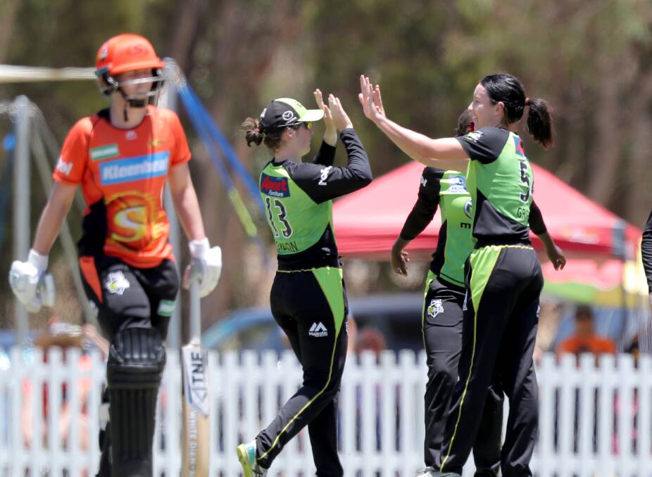 BOWLED LG: Lisa Griffith (right) is congratulated by her Sydney Thunder team-mate Maisy Gibson after dismissing Amy Jones. Photo: AAP