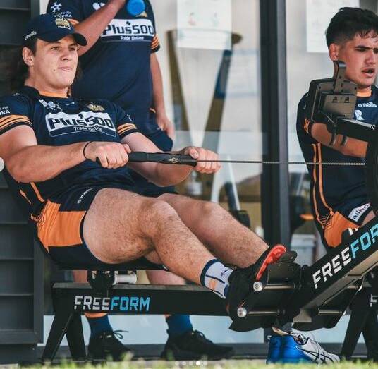 TRAINING HARD: Tom Hooper works on a rowing machine at Brumbies pre-season training. He has been confirmed in the 36-player squad.