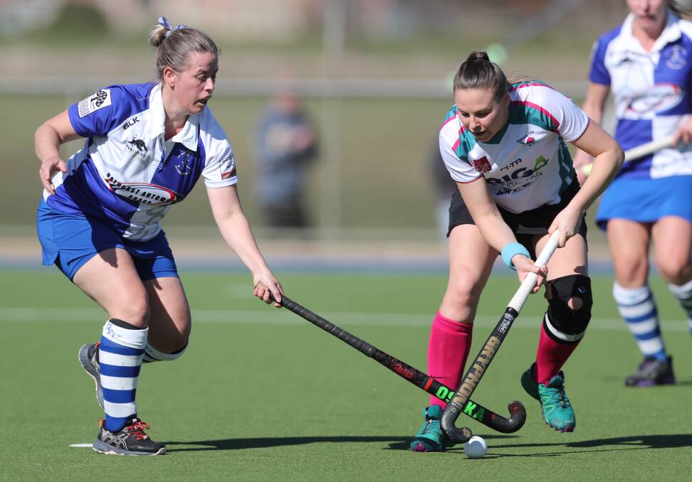 GOING DOWN FIGHTING: Bathurst City skipper Bec Bosianek tries to work the ball past St Pat's defender Lucy Weal in Saturday's match at Bob Roach Field. Photo: PHI BLATCH