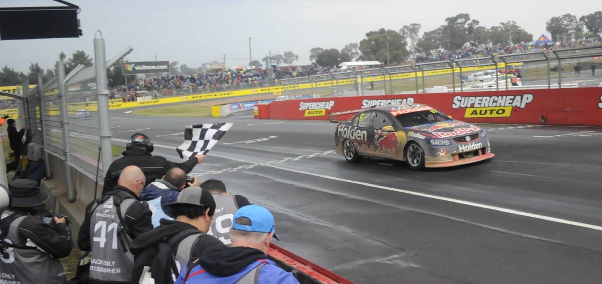 FINALLY HOME: The muddy Commodore of Shane van Gisbergen crosses the line in fifth spot. Photo: CHRIS SEABROOK