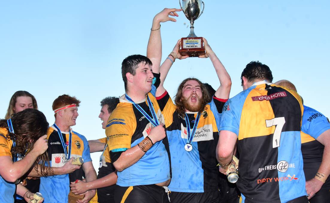 VICTOR: Xander Bennett hoists the New Holland Cup - the prize for the second-tier competition premiers.