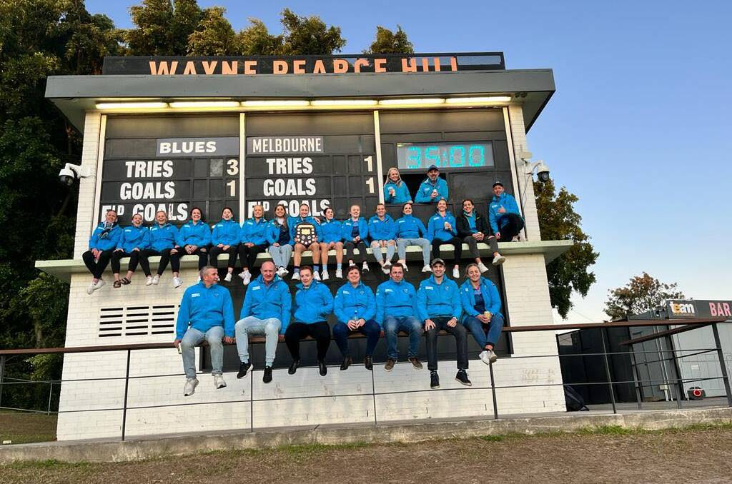 MILESTONE MOMENT: Marita Shoulders (front, centre) and her NSW team-mates pose with the scoreboard at Leichhardt Oval after their State of Origin win.