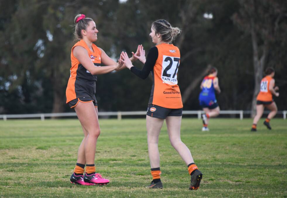 GOOD STUFF: Sarah Day (left) congratulates Giants team-mate Molly Mann after she kicked a major in the win over Dubbo. It put the Giants in outright first. Photo: AMY McINTYRE