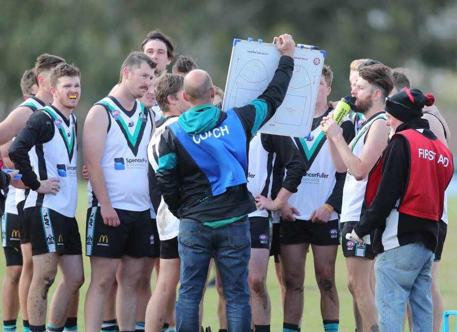 TALKING TACTICS: The Bathurst Bushrangers discuss positions and match-ups at three-quarter-time in Saturday's grand final. Photo: PHIL BLATCH