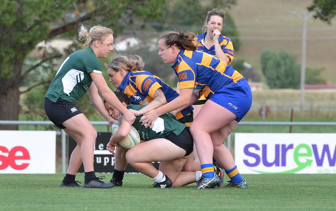 GOT YOU: Bathurst Bulldogs' Alicia Carr tackles an Orange Emus rival during last Friday's round of the Women's Summer Sevens Series. Photo: ANYA WHITELAW