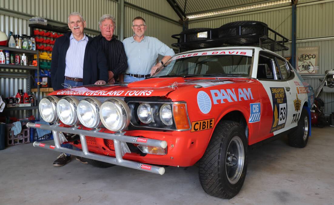 REUNITED: Checking out the restoration job on the Datsun they once raced are Arthur Davis, Rod Jones and John Latham. Photo: PHIL BLATCH
