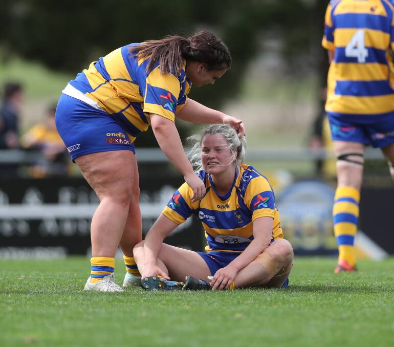 Bulldogs prop Molly Kennedy consoles team-mate Lily McIntosh after Saturday's grand final. Picture by Phil Blatch