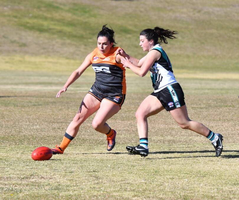 GOOD WIN: Maddie McAlister (left) and her fellow Bathurst Giants posted a good win over the Orange Tigers on Saturday. Photo: ALEXANDER GRANT