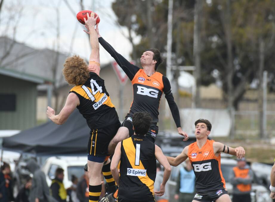 UP THERE CAZALY: Bathurst Giants' ruckman James Kennedy flies high to try and win a clearance for his side. Photo: JUDE KEOGH