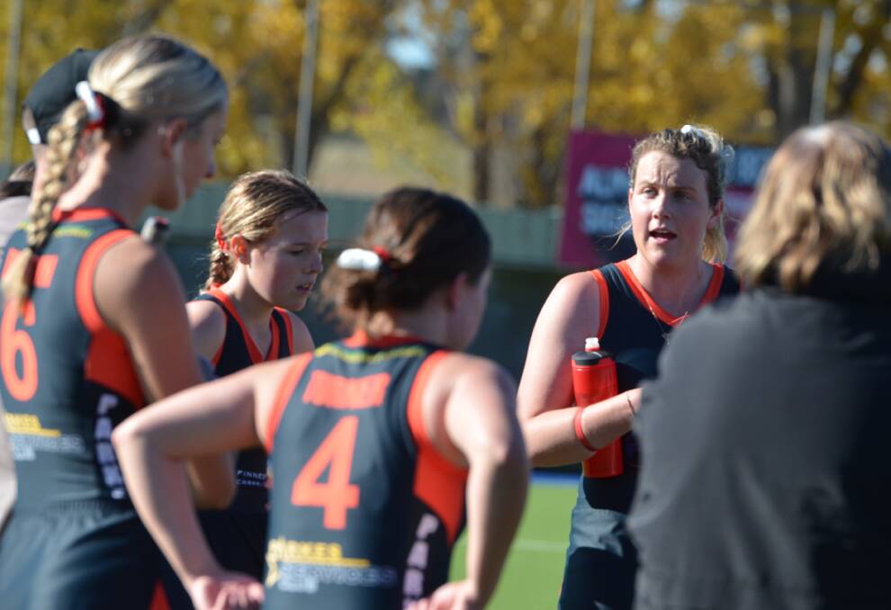 TOP FOUR: Andrea Gillard chats to her young Parkes team-mates earlier this season. Parkes is currently sitting fourth with three rounds remaining. Photo: ANYA WHITELAW