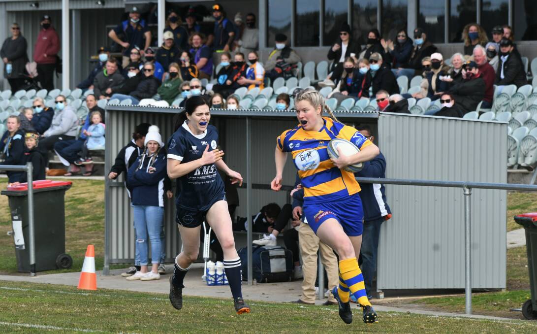 CATCH ME IF YOU CAN: Lily McIntosh runs away from her Forbes rival during the Bulldogs' last home game of the season. Photo: CHRIS SEABROOK
