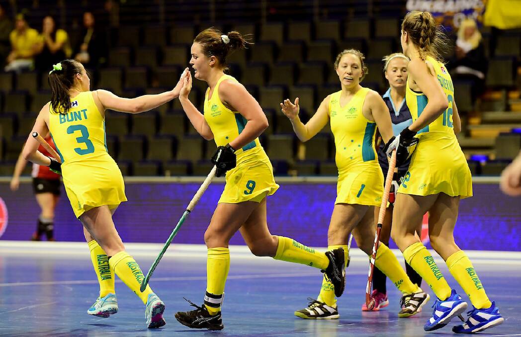 WELL DONE: Tamsin Bunt congratulates team-mate Shelley Watson after a successful play at the Women's Indoor World Cup. Photo: FIH/WORLD SPORT PICS