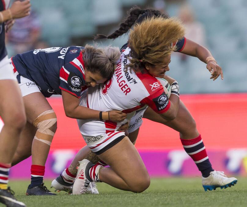 EFFORT: Bathurst league talent and now Sydney Rooster Kandy Kennedy brings down Dragons rival Oneata Schwalger in her NRLW debut. She earned her second appearance in Sunday's grand final. Photo: AAP