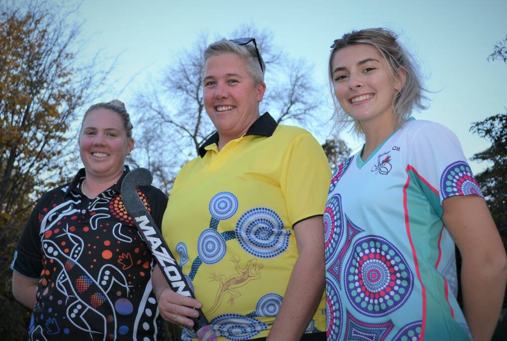 SPECIAL LOOK: Mish Somers (St Pat's), Bec Clayton (umpire) and Kelsey Webb (Bathurst City) show off special Indigenous round shirts that they will wear this Saturday.