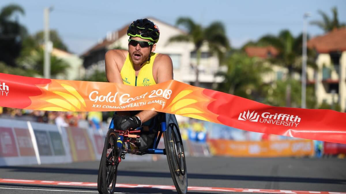 FITTING FINALE: Kurt Fearnley marked his final appearance in Australian colours by winning the inaugural Commonwealth Games men's T54 marathon. Photo: AAP, DEAN LEWINS