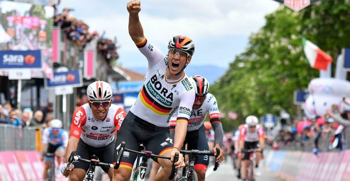 THE WINNER: Pascal Ackermann celebrates as he crosses the finish line to win the the second stage of the Giro d'Italia. The best placed rider on Mark Renshaw's team placed 11th. Photo: ANSA via AP