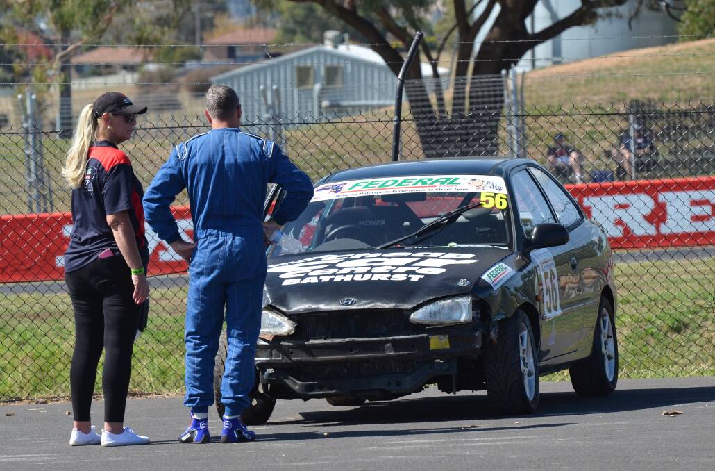 A SAD SIGHT: John Markwick examines the damage to his Hyundai Excel after being caught up in an incident. Photo: JORDAN TRELOAR