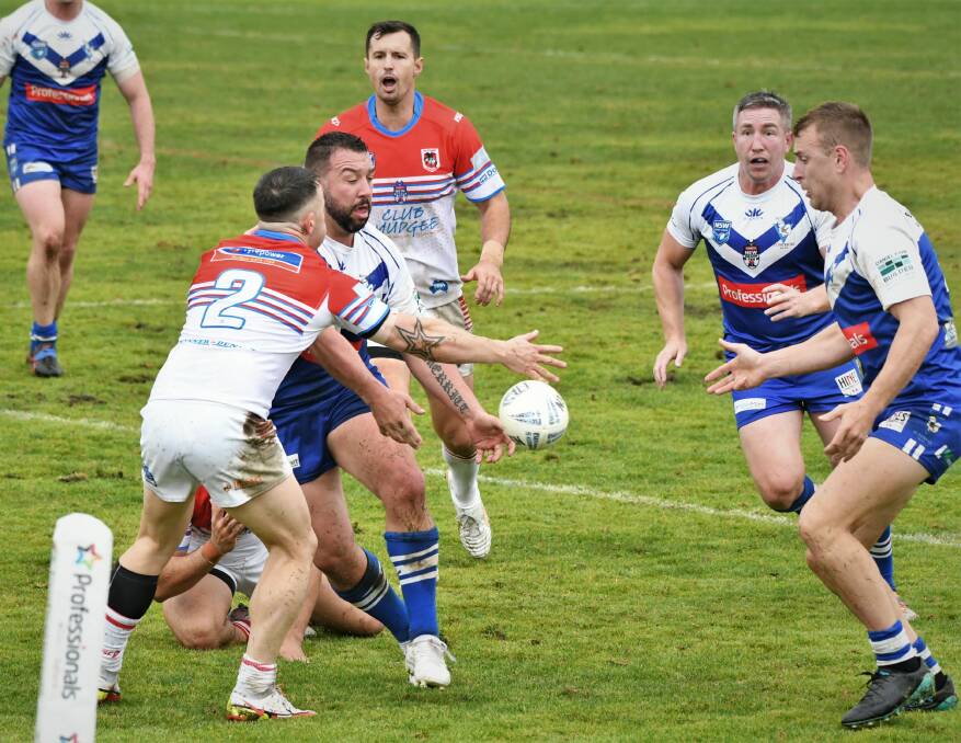 SCRAPPY DAY: Tim Holman looms in support as Saints captain Zac Merritt gets a pass away to Jackson Brien during last Sunday's match against Mudgee. Photo: CHRIS SEABROOK