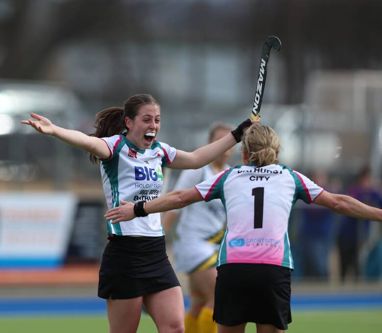 DOUBLE: Kelly Baker (left) celebrates with team-mate Lisa Quinn after scoring one of her two goals.