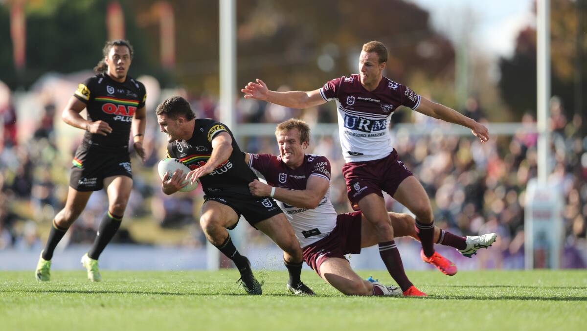 RULED OUT: Penrith star Nathan Cleary, pictured trying to avoid Manly's Jake Trbojevic and Daly Cherry-Evans at Carrington Park last year, has been ruled out of the game in Bathurst later this month. Photo: PHIL BLATCH