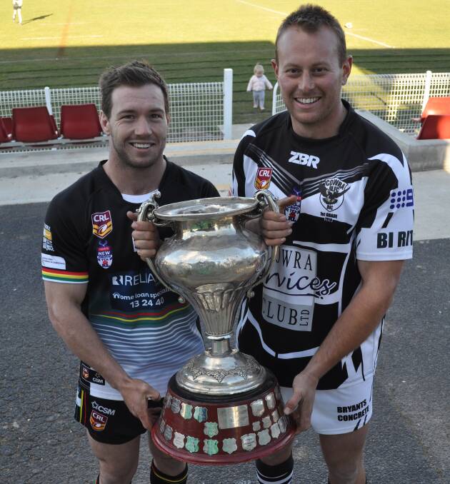 ONE HAND ON THE PRIZE: Panthers skipper Doug Hewitt with Cowra captain Josh Rainbow and the Western Challenge Cup, the prize for winning the Group 10 premier league competition. Photo: NICK McGRATH
