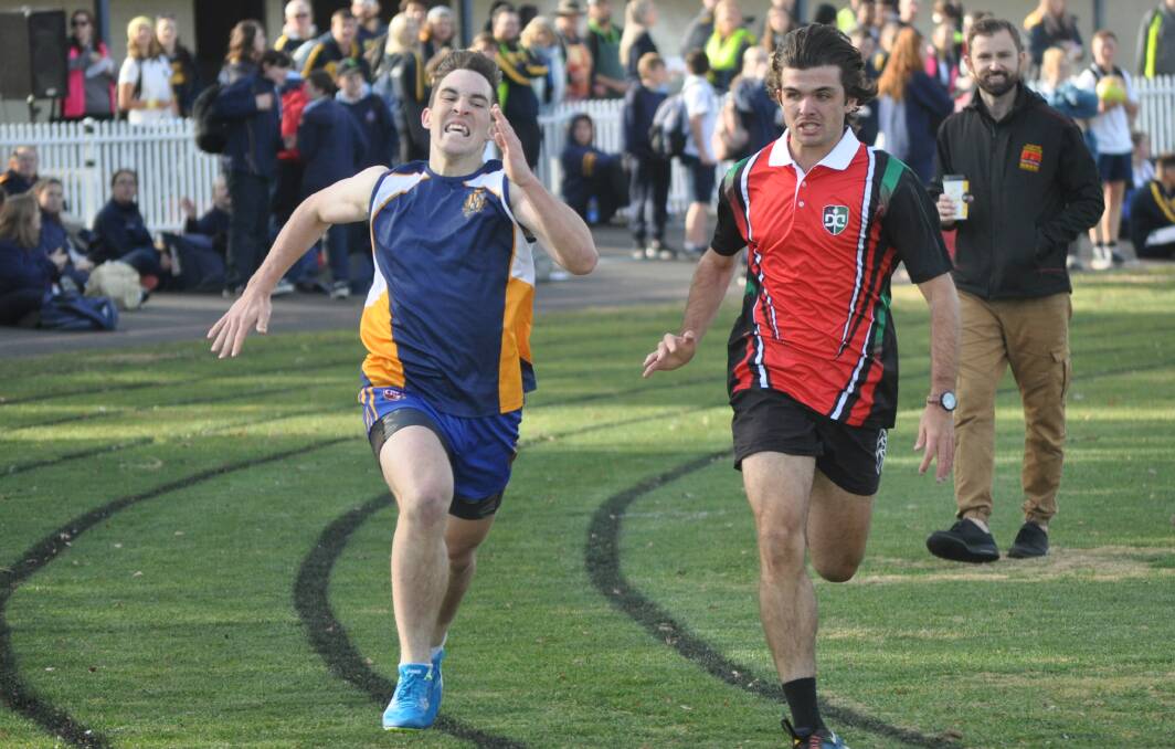 COMING THROUGH: Pat Halsey and Brock Larance go toe-to-toe in the 800 metres at the Bathurst Sportsground. Photo: NICK McGRATH