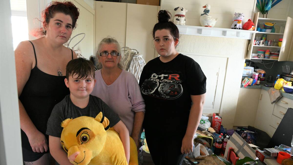Julie Vidler, with children Hayley left Kaleb 8 and Amanda Lowe Their home on Wyrallah Rd in East Lismore has been destroyed.jpg
