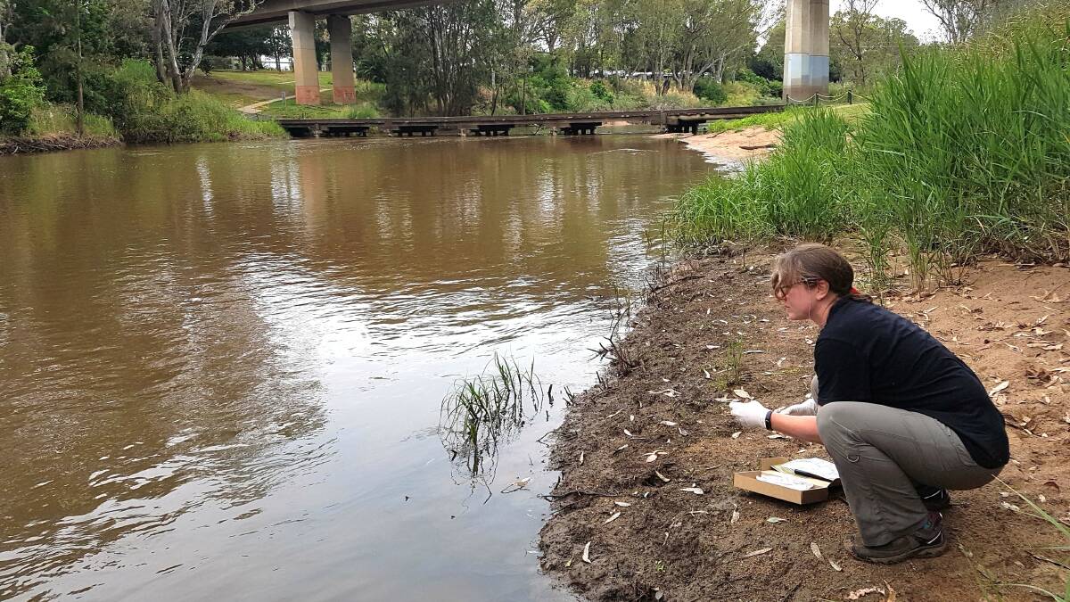 A Mid Lachlan Landcare member conducting a water test of the Lachlan River.