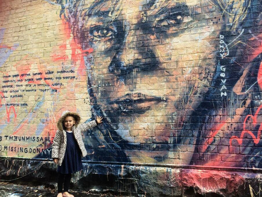 LOVE: Little Harmony O'Keane, 4, with a mural in Melbourne of her Ballarat uncle, Donny Govan, who went missing just a few days before she was born in 2012.