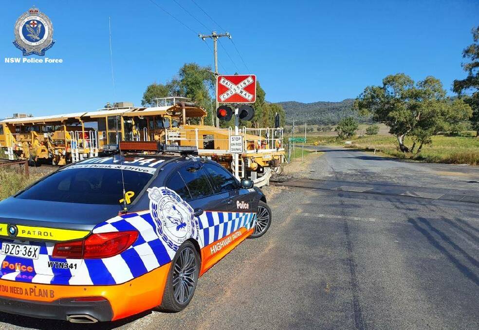 FOCUS: A highway patrol car at a level crossing on the Bylong Valley Way, police will continue targeting dangerous driving at level crossings. Photo: NSW POLICE FORCE